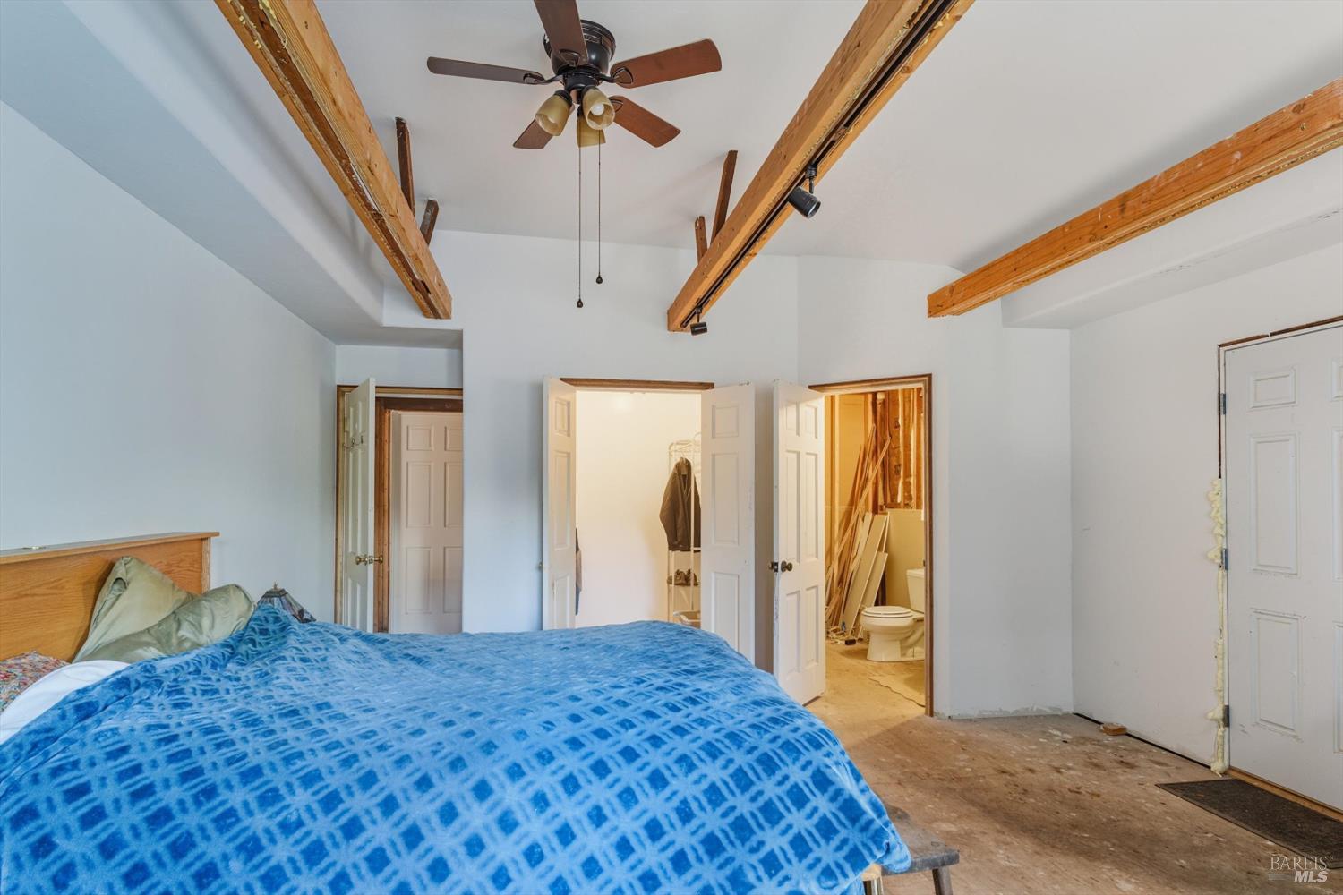 5070 Blank Road Sebastopol, CA 95472 - Photo 35 of 36 a bedroom with a bed and a chandelier