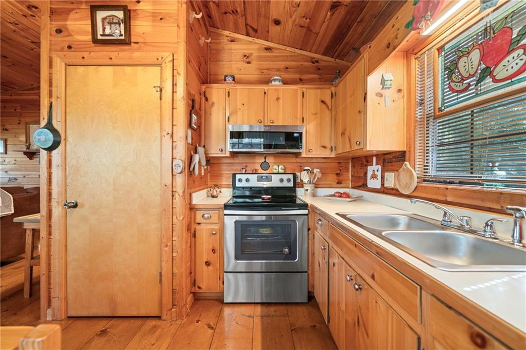 301 Laurel Creek Road Blue Ridge, GA 30513 - Photo 11 of 36 a kitchen with granite countertop a sink and a refrigerator