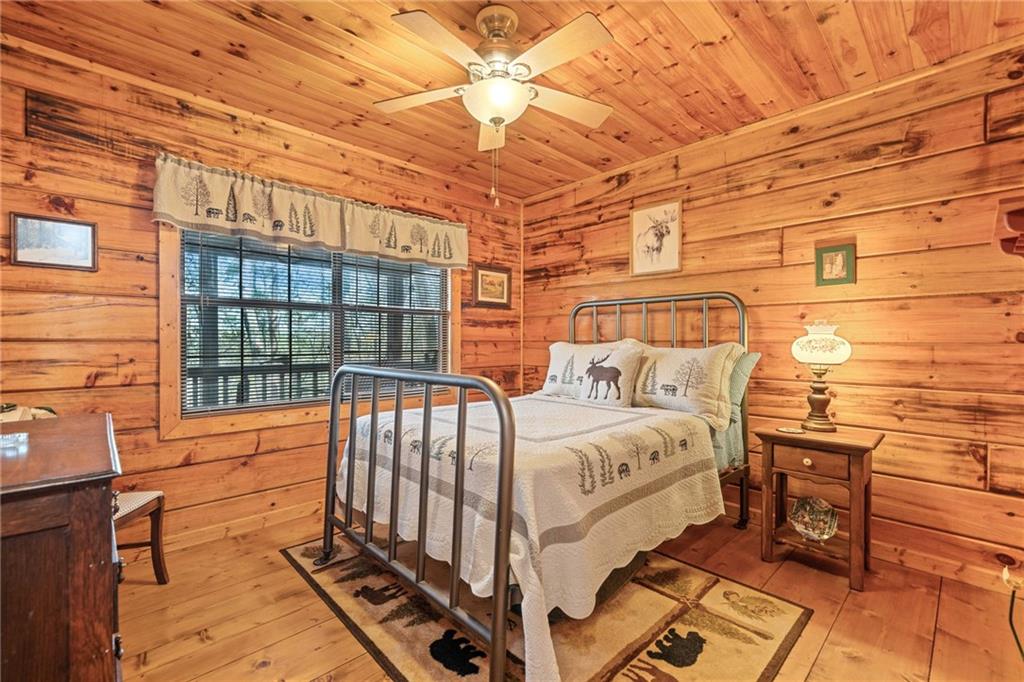301 Laurel Creek Road Blue Ridge, GA 30513 - Photo 15 of 36 a bed sitting in a bedroom next to a window