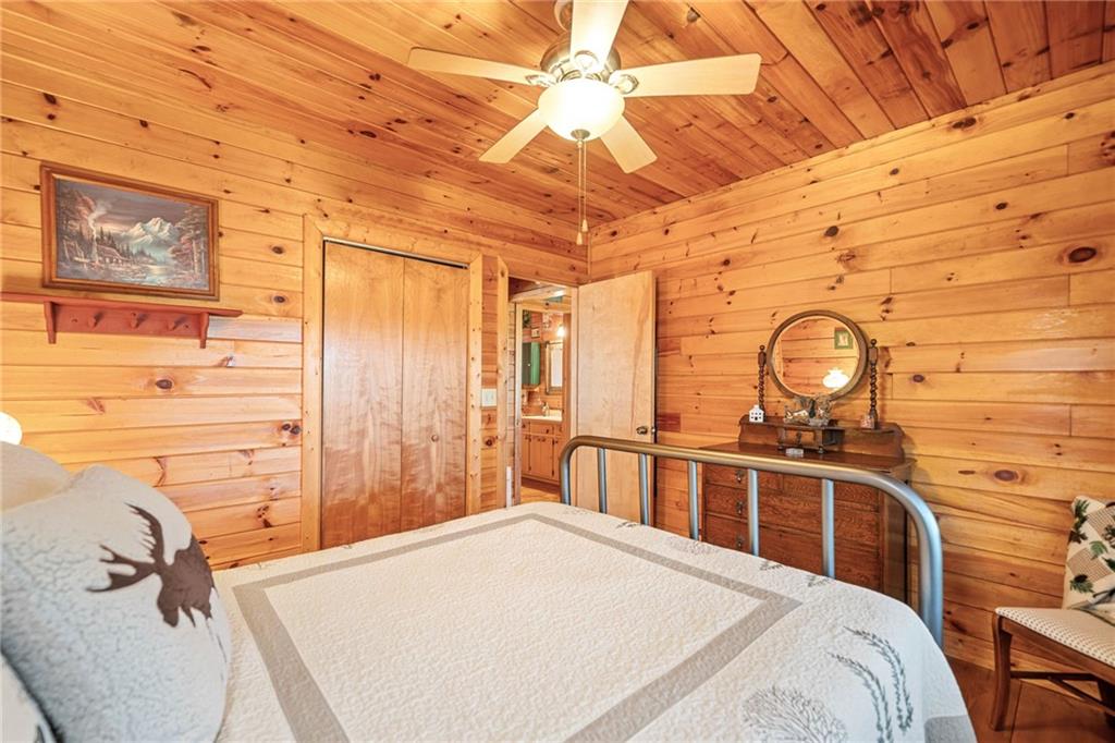 301 Laurel Creek Road Blue Ridge, GA 30513 - Photo 16 of 36 a bedroom with a bed mirror and a window