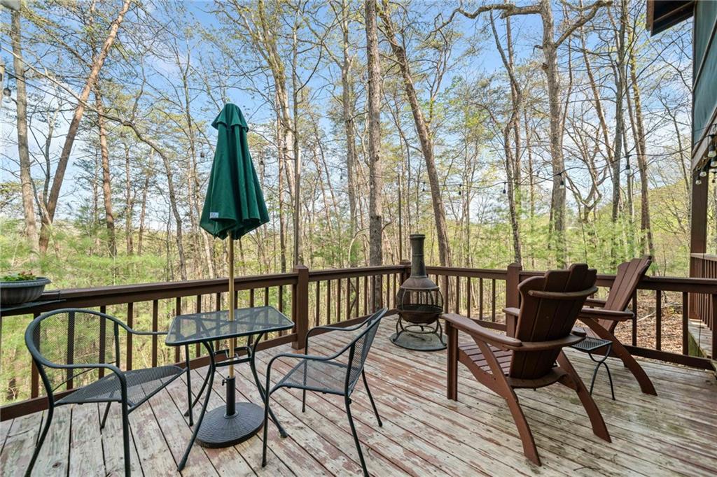 301 Laurel Creek Road Blue Ridge, GA 30513 - Photo 22 of 36 a view of a chairs and table on the deck