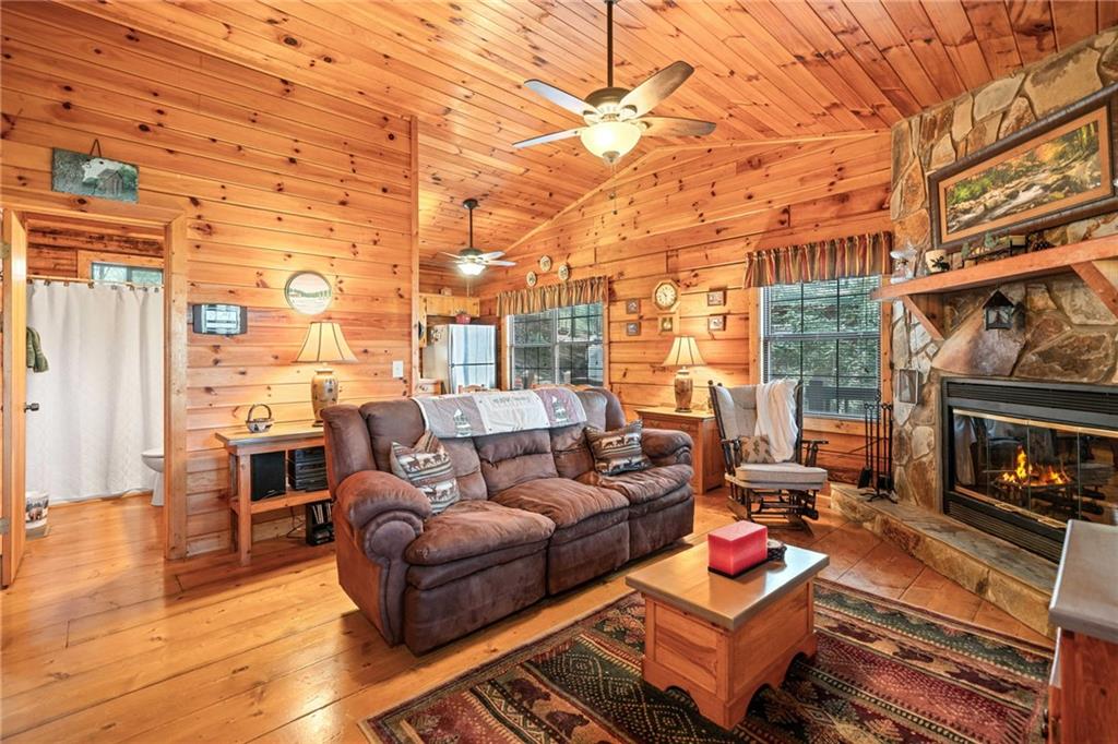 301 Laurel Creek Road Blue Ridge, GA 30513 - Photo 5 of 36 a living room with furniture a fireplace and wooden floor
