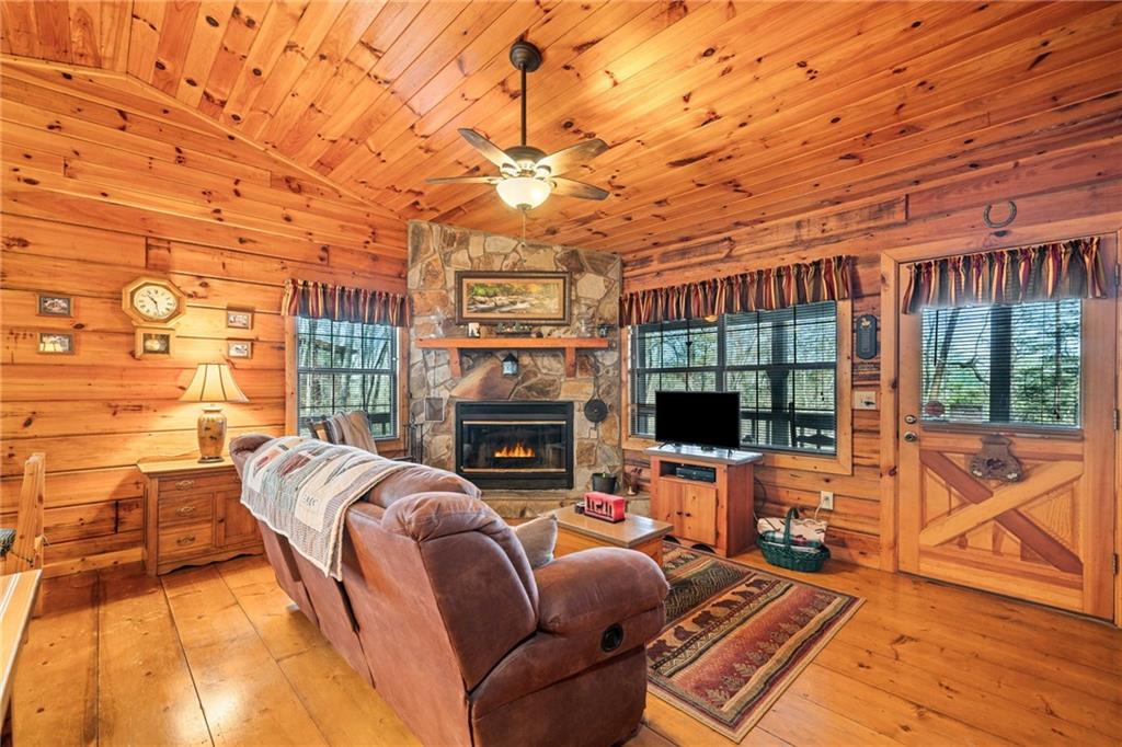 301 Laurel Creek Road Blue Ridge, GA 30513 - Photo 7 of 36 a living room with furniture a fireplace and a flat screen tv
