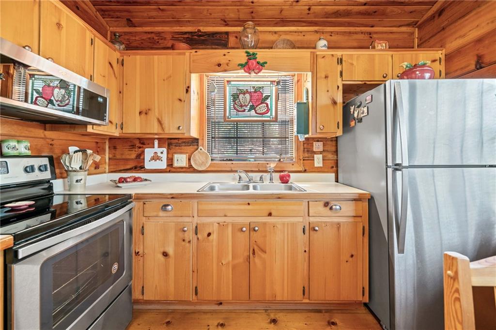 301 Laurel Creek Road Blue Ridge, GA 30513 - Photo 10 of 36 a utility room with stainless steel appliances granite countertop a refrigerator and a stove