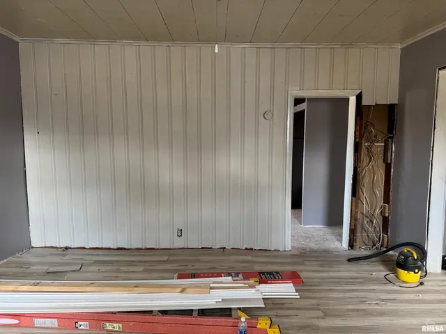 a view of a door and wooden floor