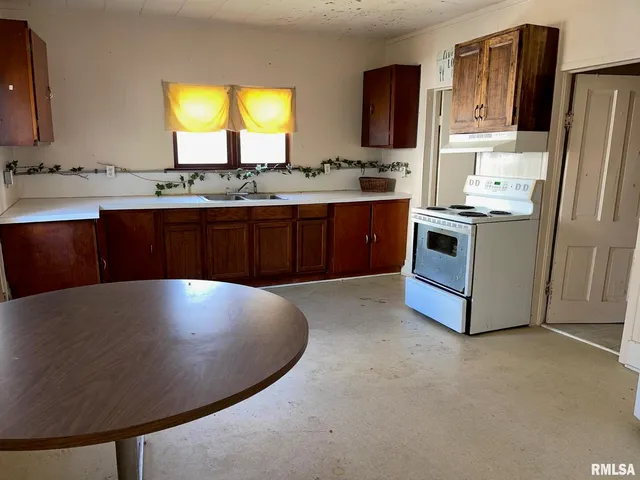 a view of a kitchen with a sink and a refrigerator