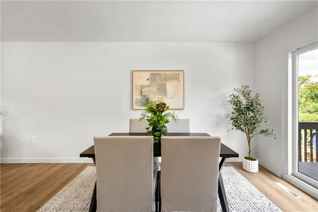 a view of a livingroom with furniture and a potted plant