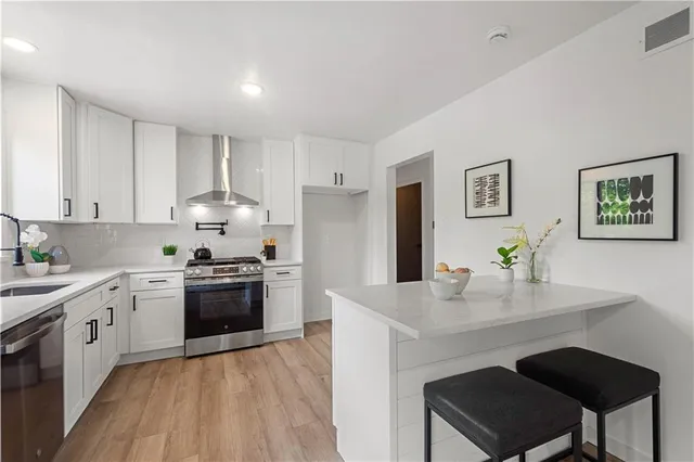 a kitchen with a white cabinets and appliances