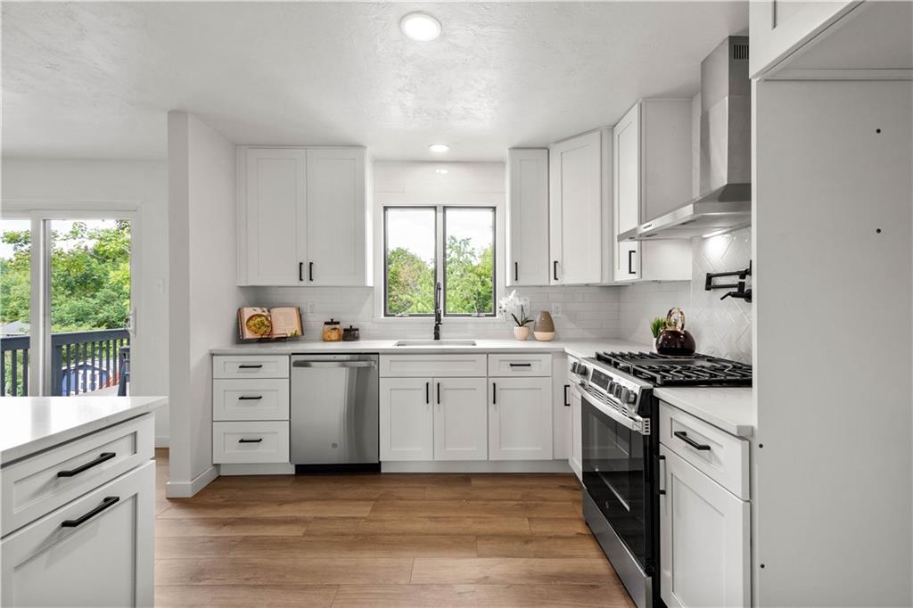 1546 West Ingomar Road Pittsburgh, PA 15237 - Photo 17 of 49 a kitchen with white cabinets appliances and a window