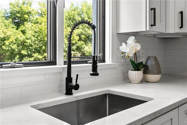 a stove top oven sitting inside of a kitchen