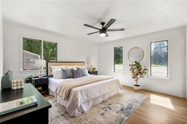 a bedroom with a large bed and a chandelier