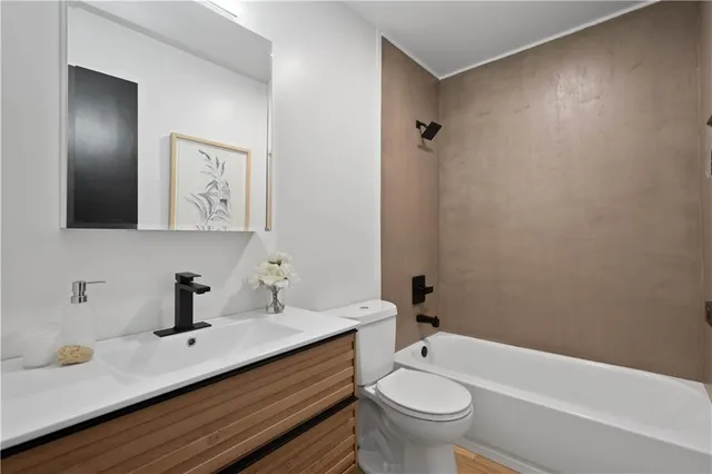 a bathroom with a sink a toilet and a mirror