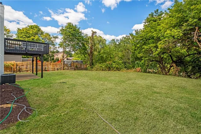 a view of an house with backyard space and garden