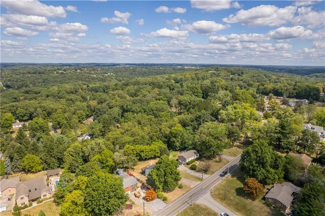 an aerial view of residential building and car parked