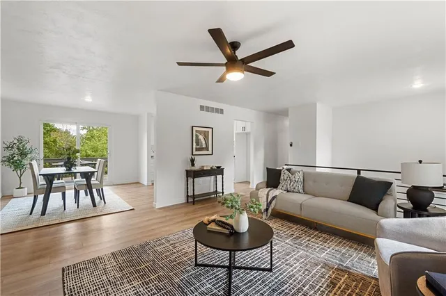 a living room with furniture and a potted plant