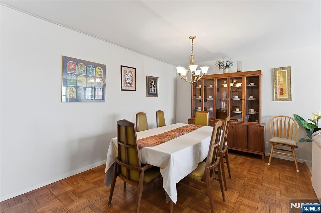 280 Prospect Avenue, Unit 8G Hackensack, NJ 07601 - Photo 12 of 23 a view of a dining room with furniture and chandelier
