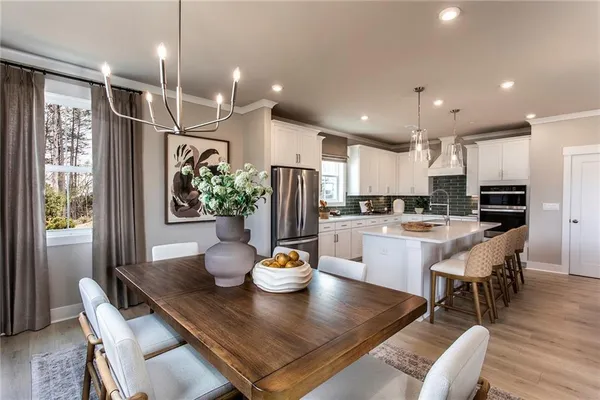 a kitchen with a table and chairs