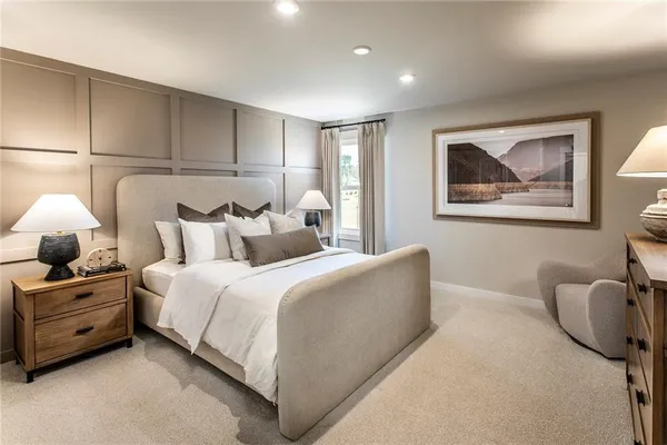 a bedroom with a large bed and a chandelier
