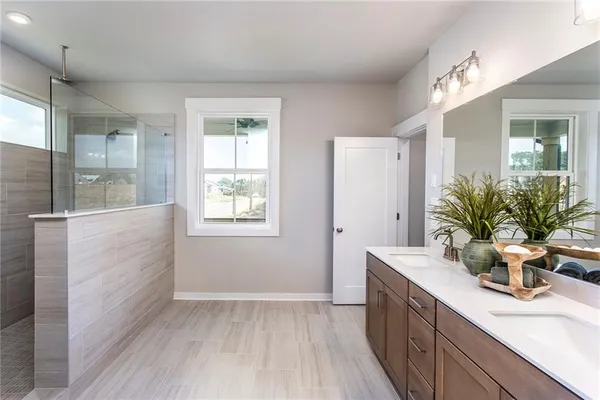 a bathroom with a sink double vanity and a mirror