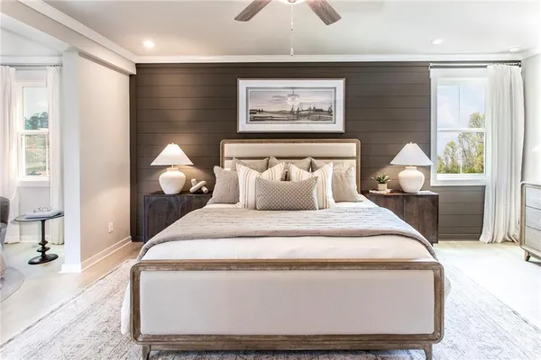 a spacious bedroom with a bed and a chandelier