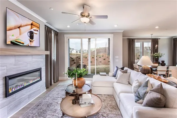 a living room with furniture potted plant and a fireplace