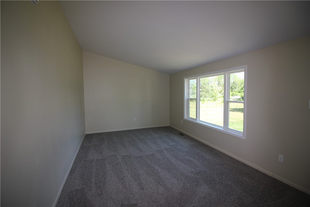 6655 North Centenary Road Williamson, NY 14589 - Photo 21 of 23 Living room with vaulted ceiling