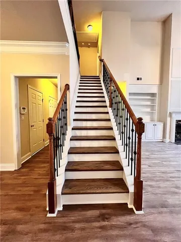 a view of entryway and hall with wooden floor