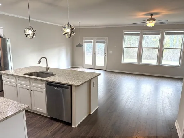 a kitchen with sink cabinets and wooden floor