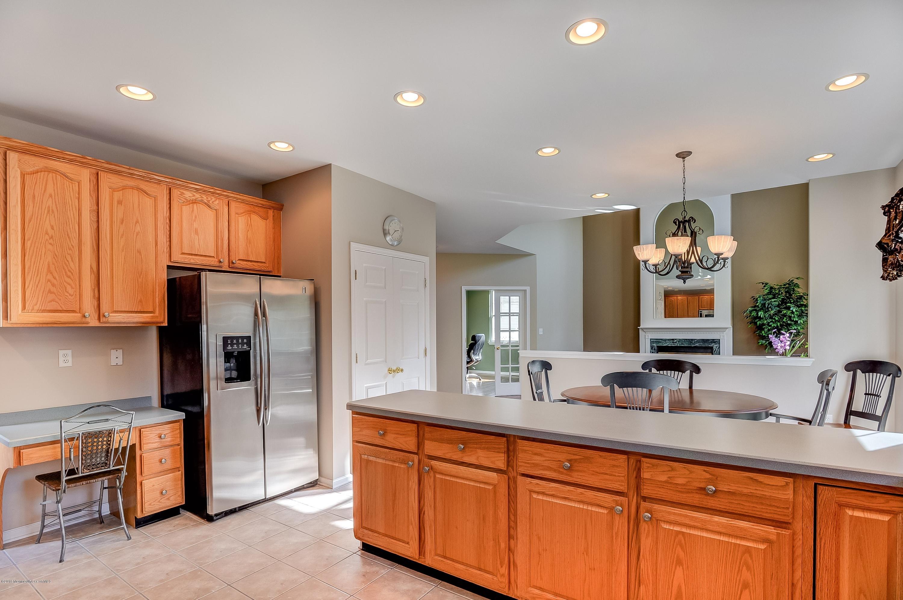 323 Wedgewood Road Morganville, NJ 07751 - Photo 12 of 27 a large kitchen with stainless steel appliances granite countertop a refrigerator and a sink