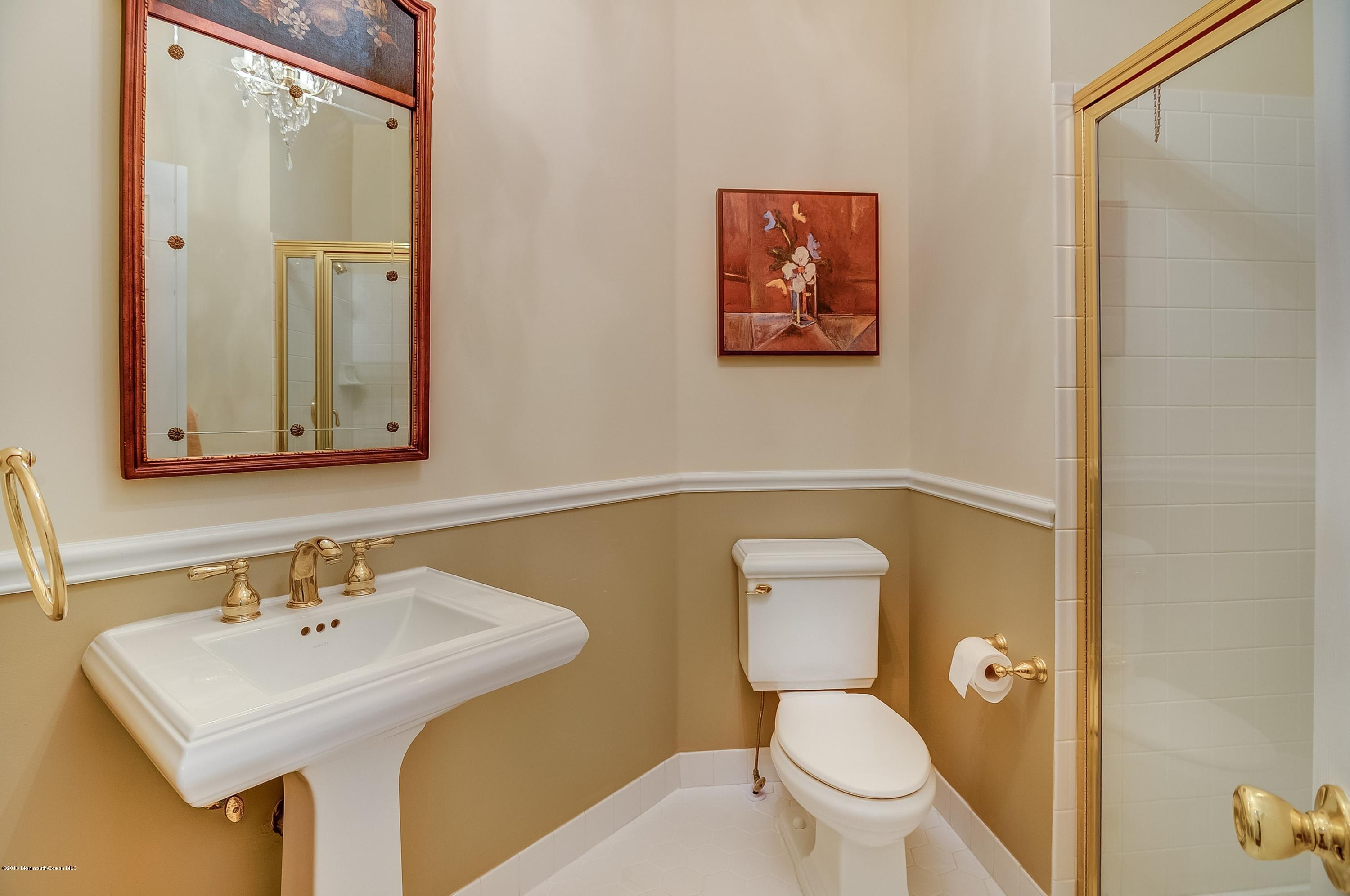 323 Wedgewood Road Morganville, NJ 07751 - Photo 14 of 27 a bathroom with a toilet sink and mirror