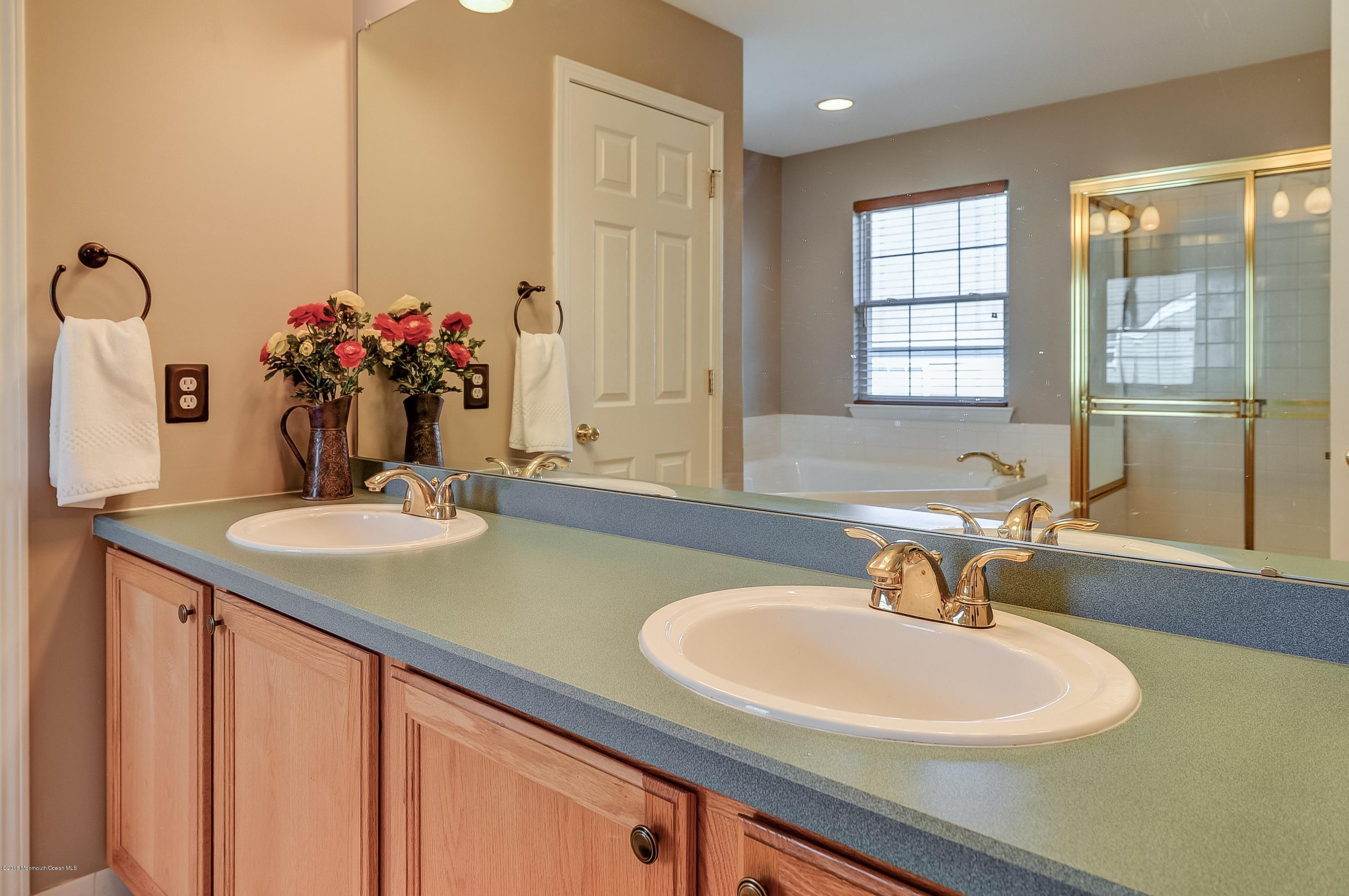323 Wedgewood Road Morganville, NJ 07751 - Photo 18 of 27 a bathroom with a sink and a mirror
