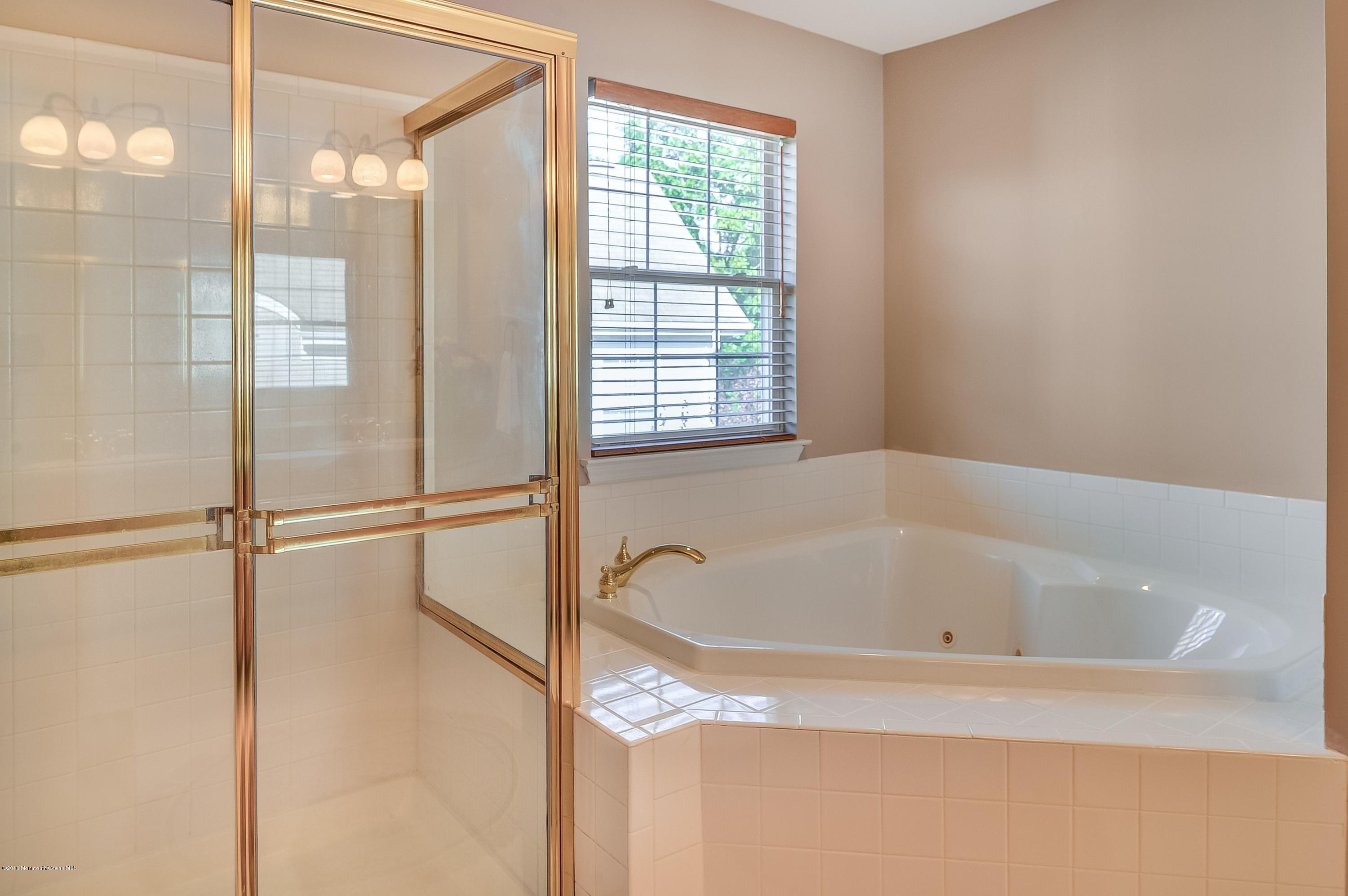 323 Wedgewood Road Morganville, NJ 07751 - Photo 19 of 27 a bathroom with a bathtub and shower