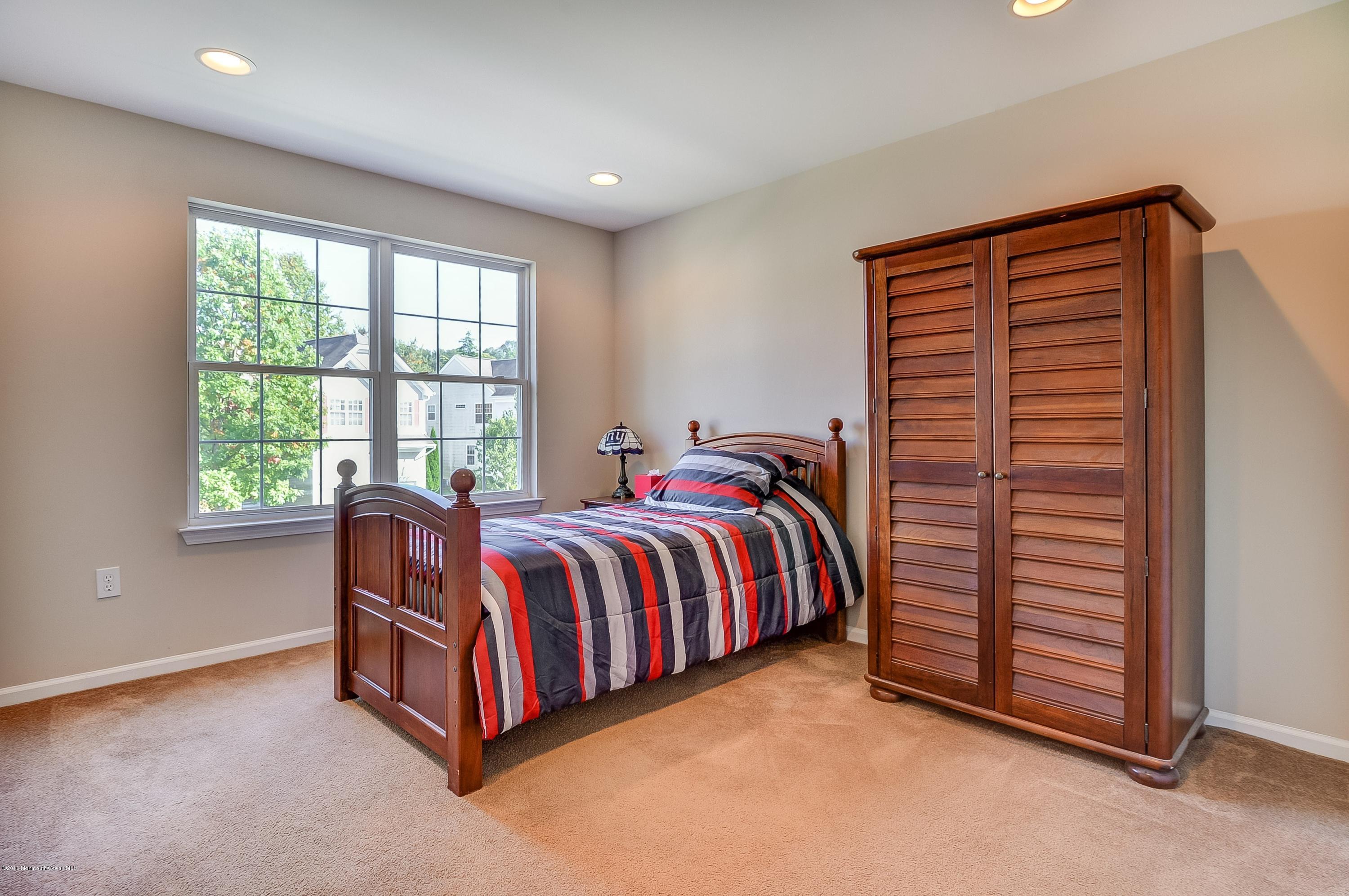 323 Wedgewood Road Morganville, NJ 07751 - Photo 20 of 27 a spacious bedroom with a bed and a window