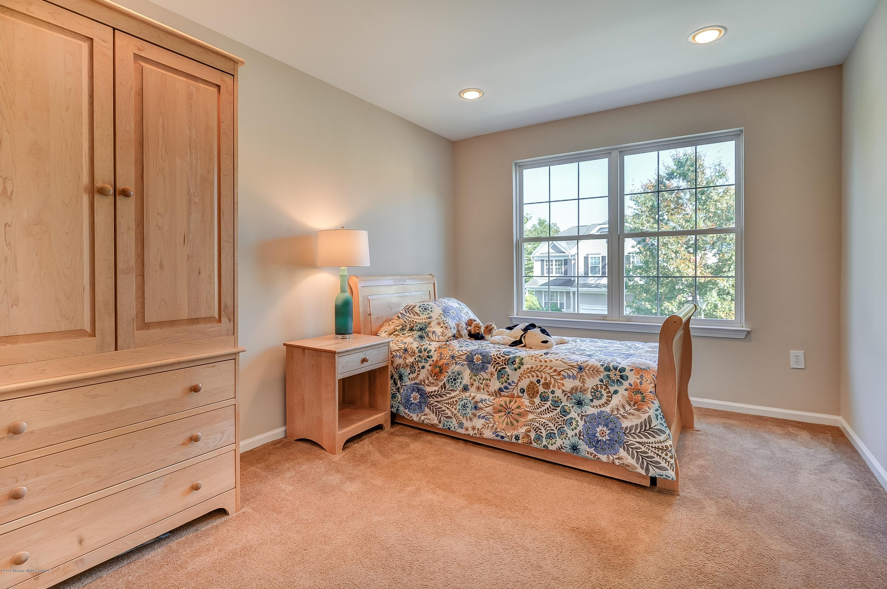 323 Wedgewood Road Morganville, NJ 07751 - Photo 21 of 27 a bed room with a bed and a window