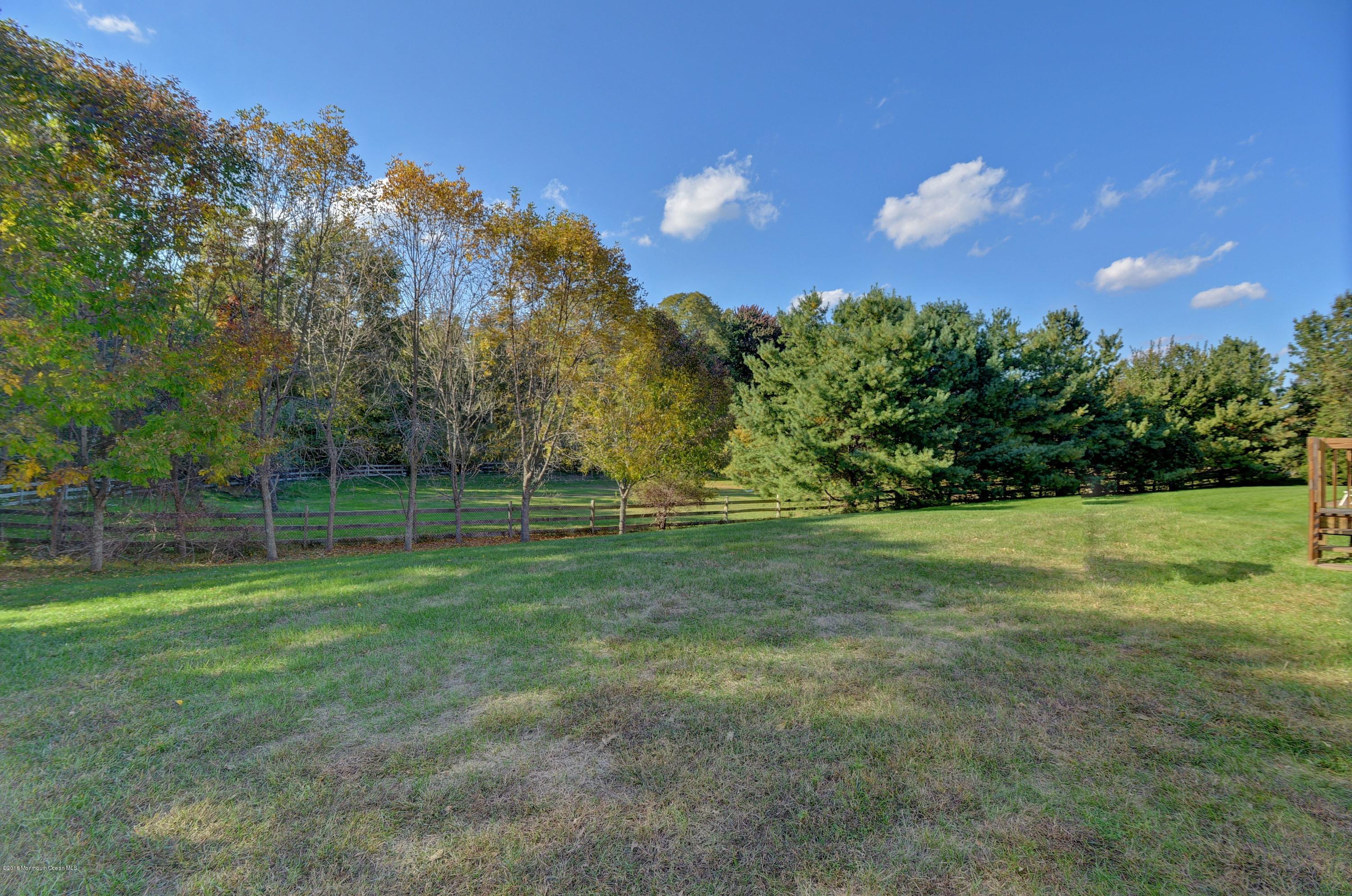 323 Wedgewood Road Morganville, NJ 07751 - Photo 25 of 27 a view of outdoor space with deck and trees all around