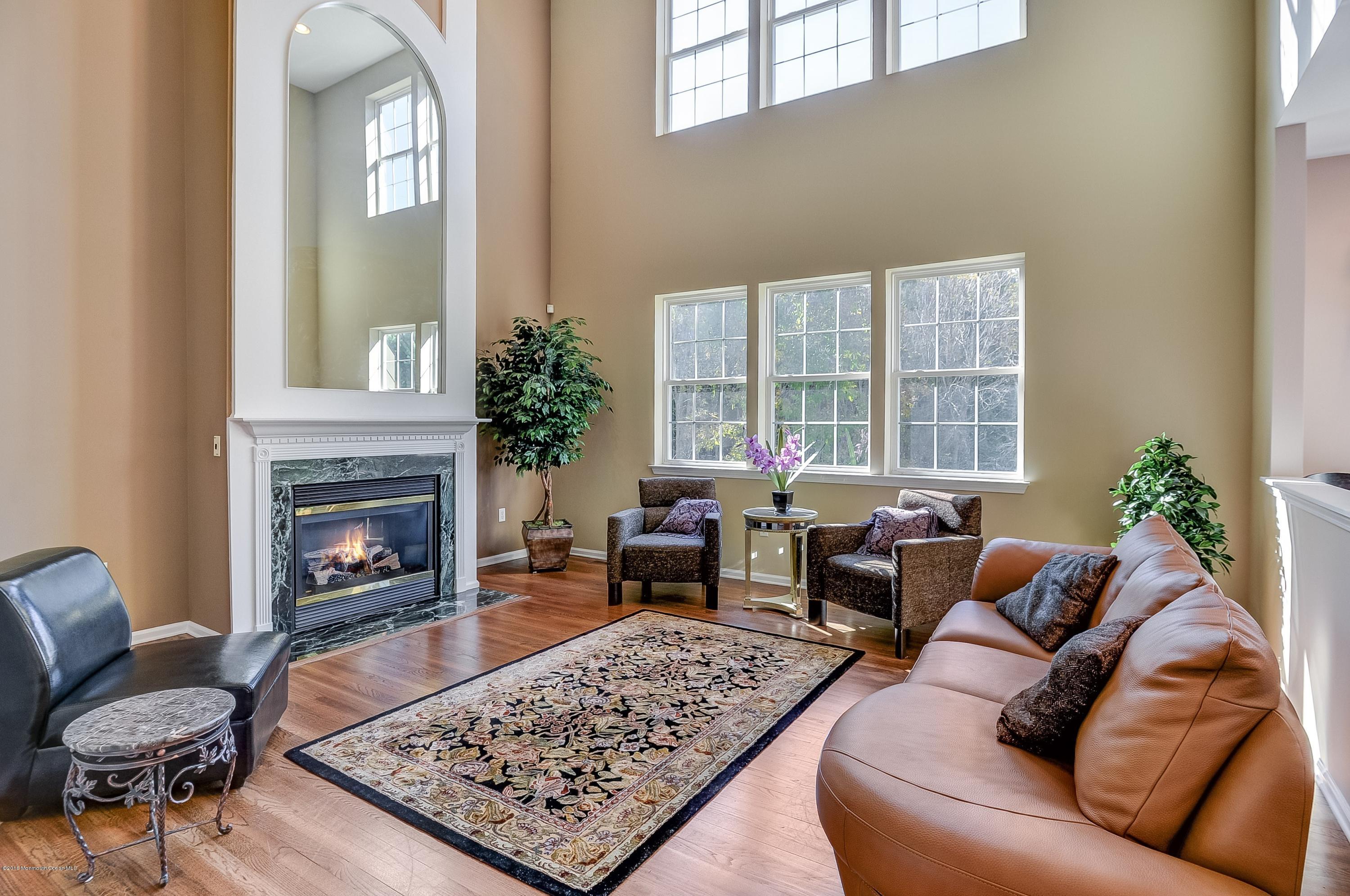 323 Wedgewood Road Morganville, NJ 07751 - Photo 6 of 27 a living room with furniture and a fireplace