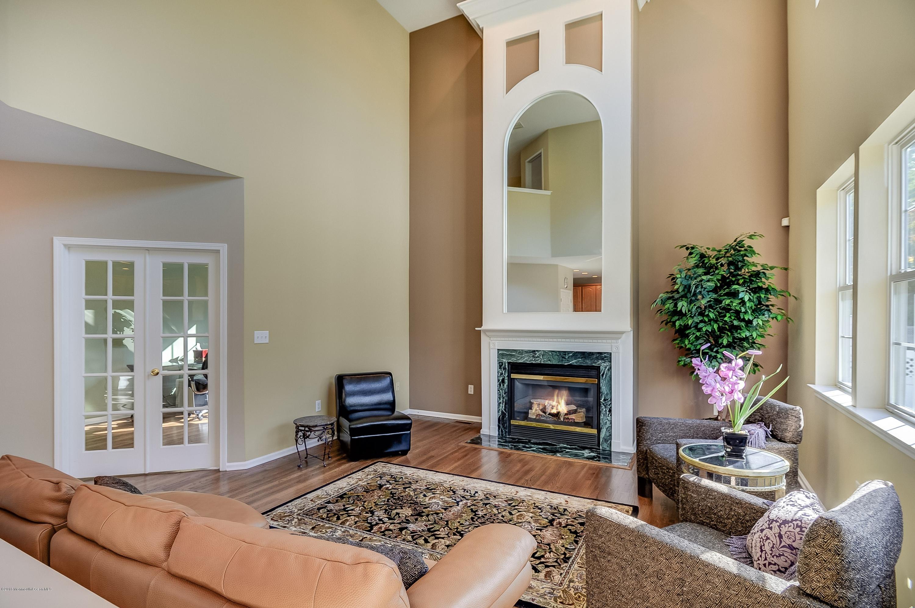 323 Wedgewood Road Morganville, NJ 07751 - Photo 7 of 27 a living room with furniture fireplace and potted plants