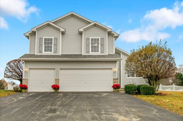 a view of a house with a road and a garage