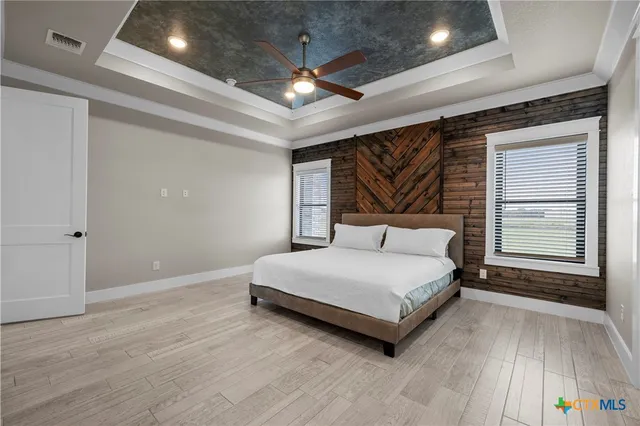 a spacious bedroom with a bed and a window