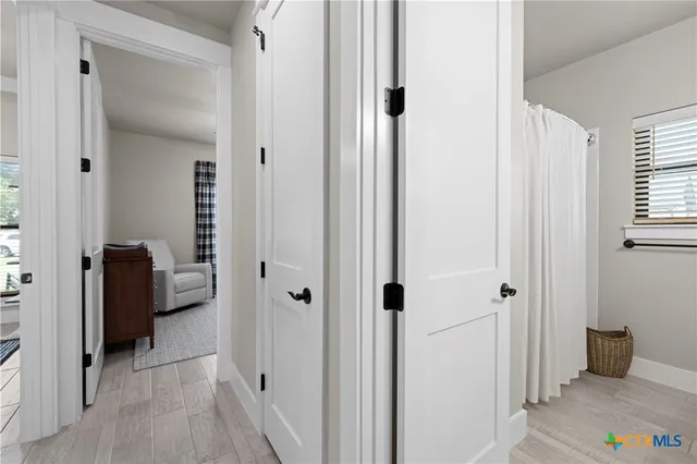 a view of a bathroom from a hallway