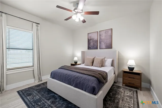 a bedroom with bed and a window