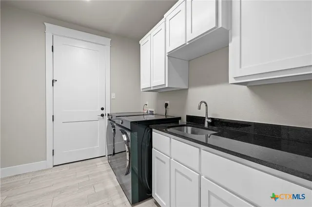 a kitchen with a sink and cabinets