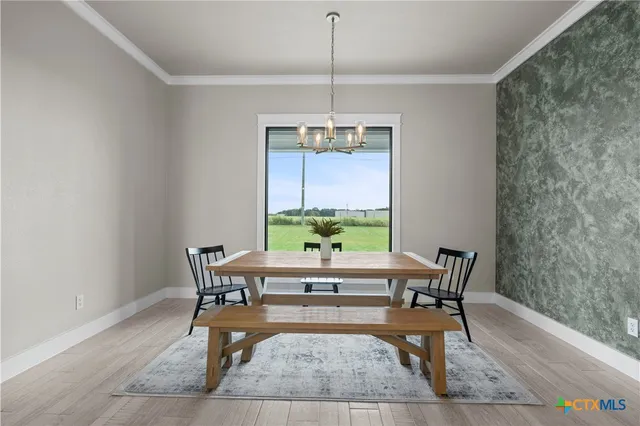 a dining room with a table and chairs
