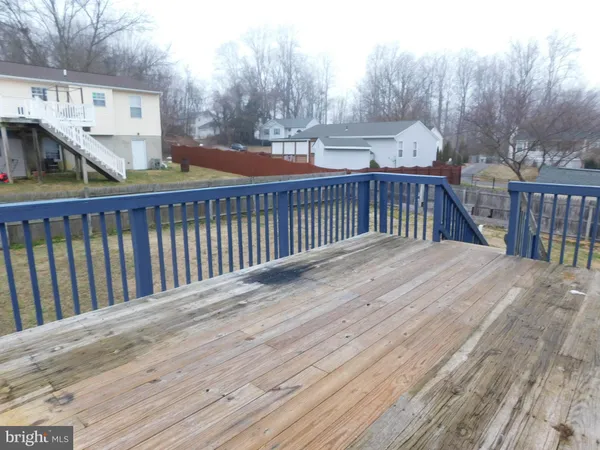 a balcony with wooden floor and fence