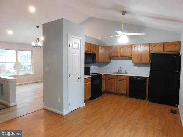 a kitchen with a refrigerator and a stove top oven