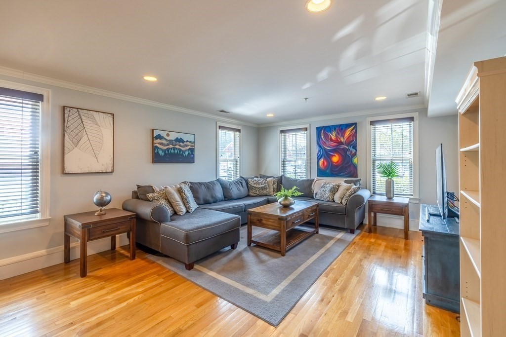 a living room with furniture fireplace and a window