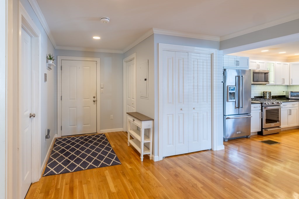 75 Main Street, Unit 102 Amesbury, MA 01913 - Photo 11 of 28 a bedroom with a bed and wooden floor