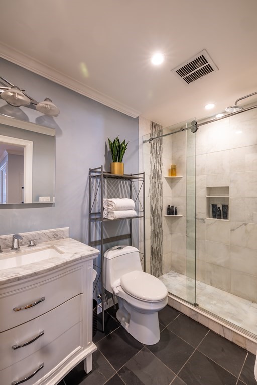 75 Main Street, Unit 102 Amesbury, MA 01913 - Photo 12 of 28 a bathroom with a toilet a sink and shower
