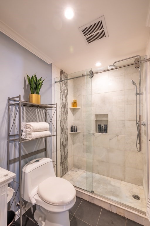 75 Main Street, Unit 102 Amesbury, MA 01913 - Photo 13 of 28 a bathroom with a toilet and a shower