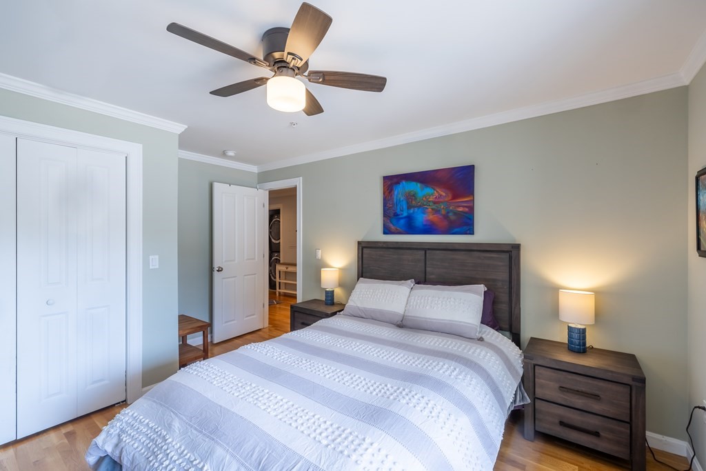 75 Main Street, Unit 102 Amesbury, MA 01913 - Photo 18 of 28 a bedroom with a bed and a lamp